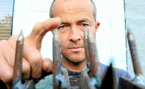Dave Gittins with the metal trap he found at Fingal Head. The road spike was constructed with six-inch bolts welded onto a metal plate. Dave Gittins with the metal trap he found at Fingal Head. The road spike was constructed with six-inch bolts welded onto a metal plate.